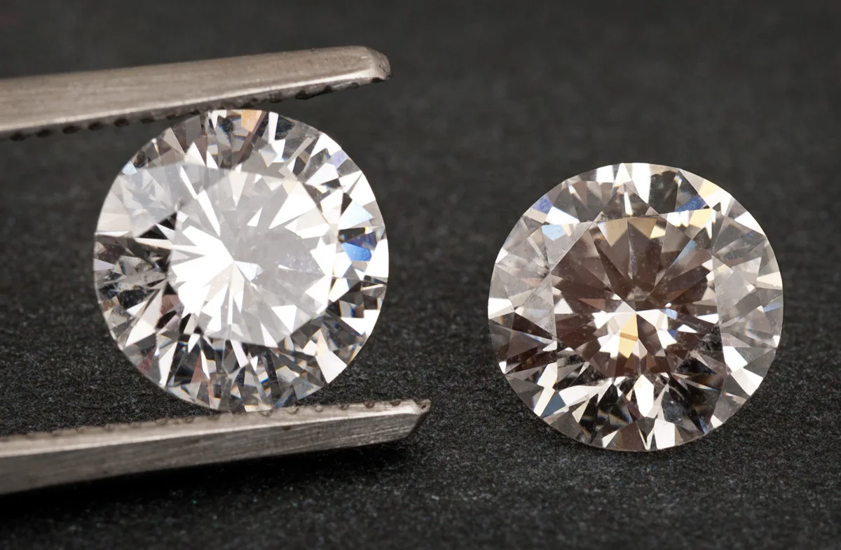 Two round brilliant diamonds side by side, one held in tweezers: a lab-grown diamond and a mined diamond look the same